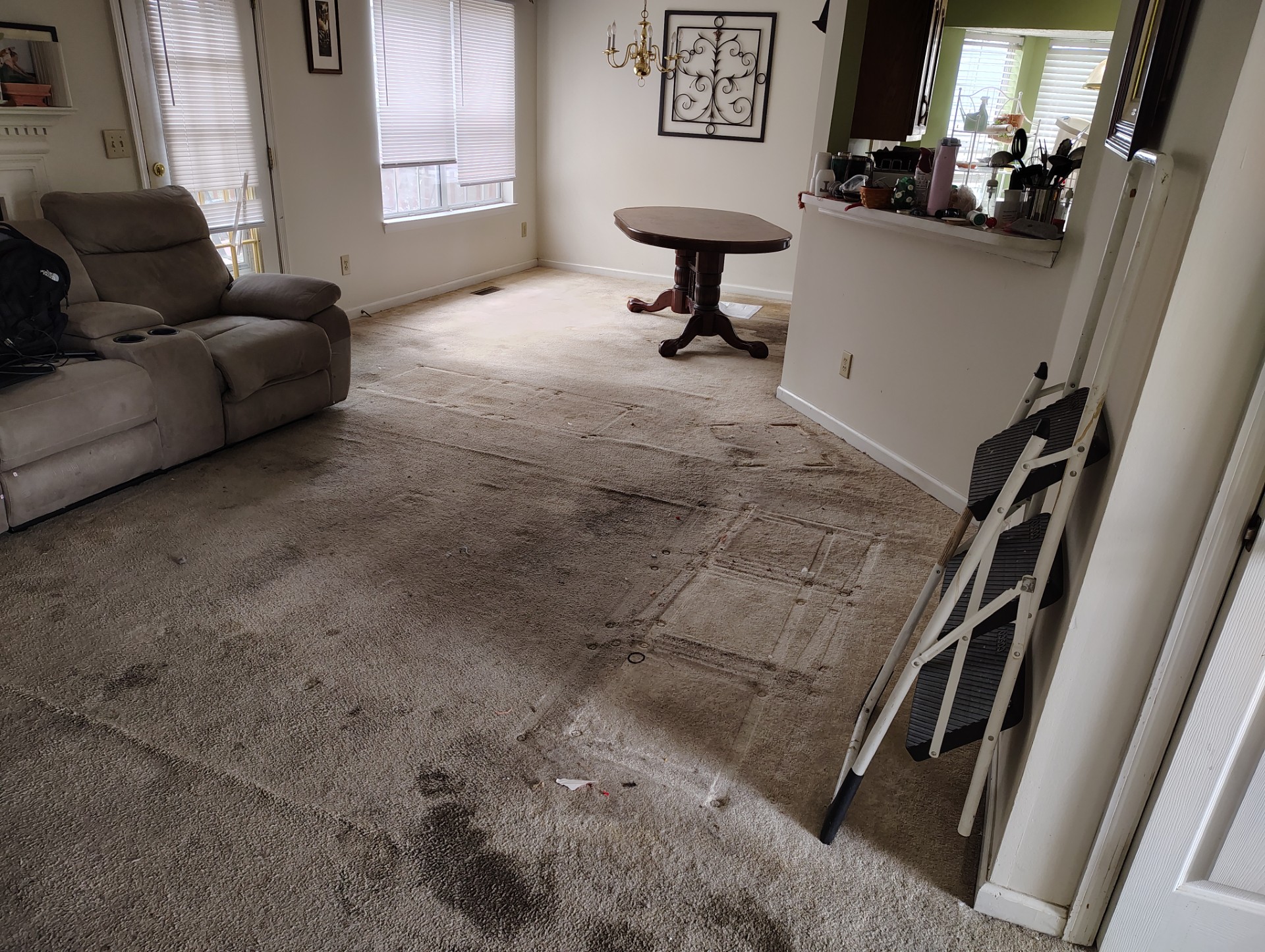 Family room with carpet before it is replaced with Luxury Vinyl Plank flooring